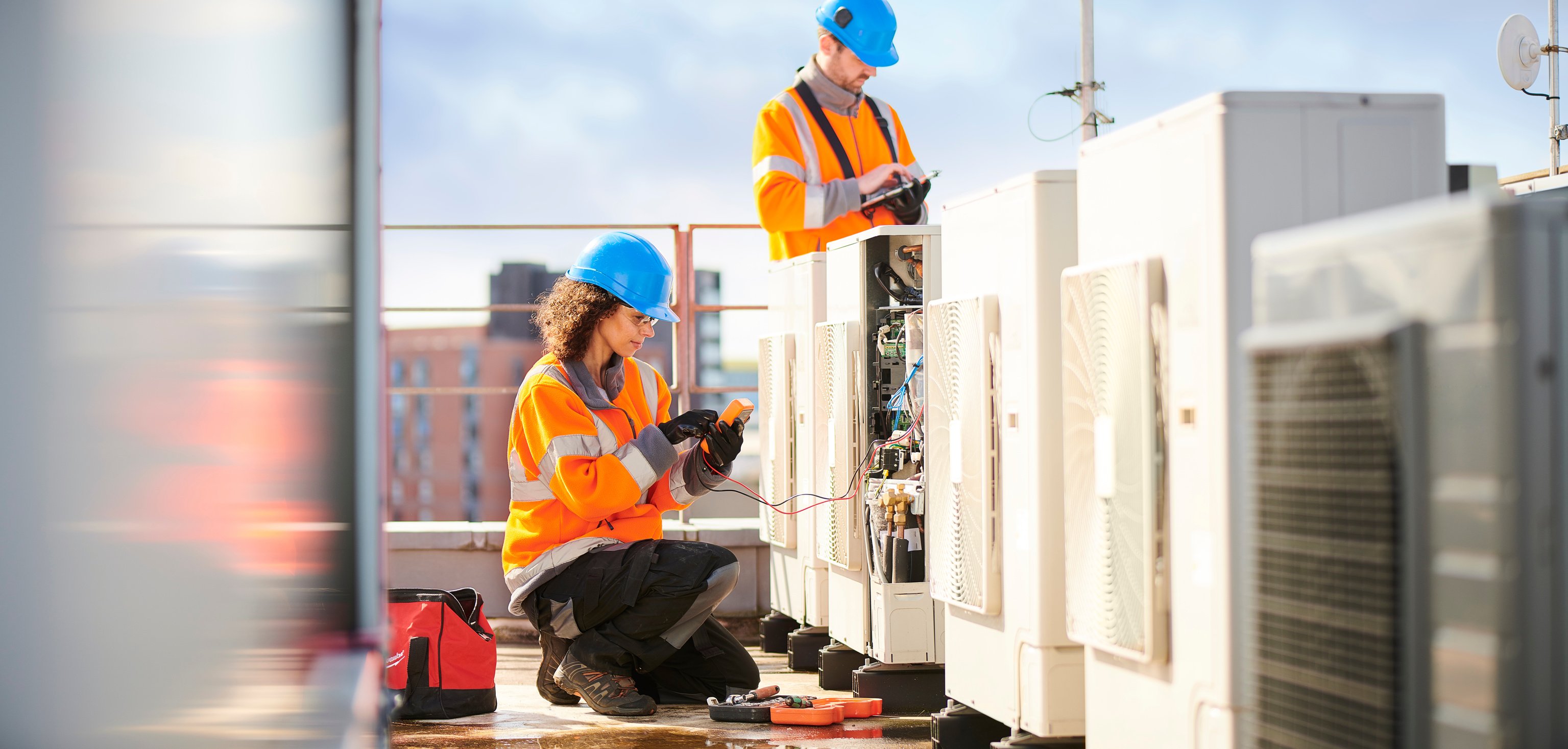 female electrician with aircon unit